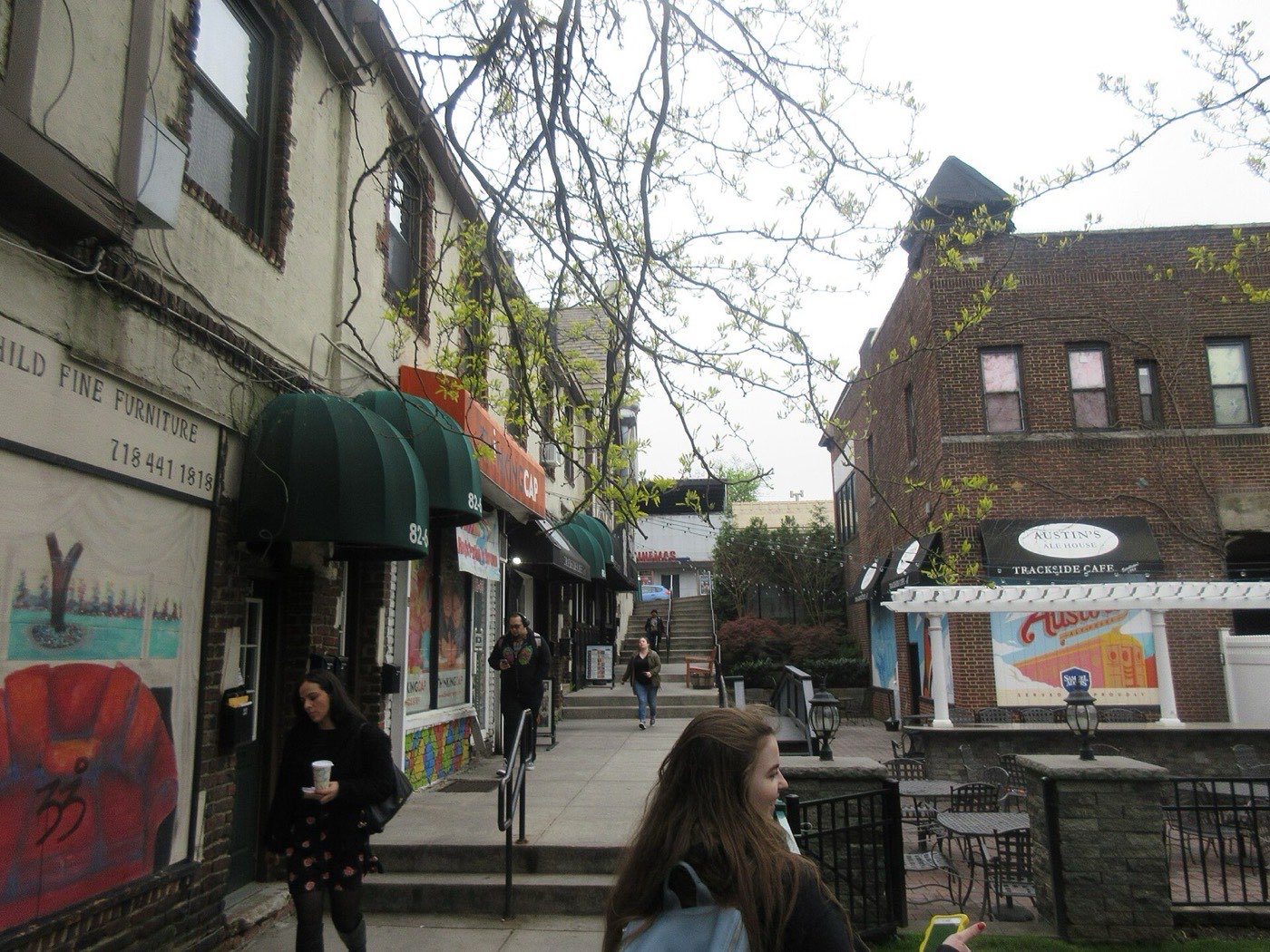 A narrow alleyway running between buildings from the Kew Gardens Long Island Rail Road station toward Lefferts Boulevard in Queens, New York