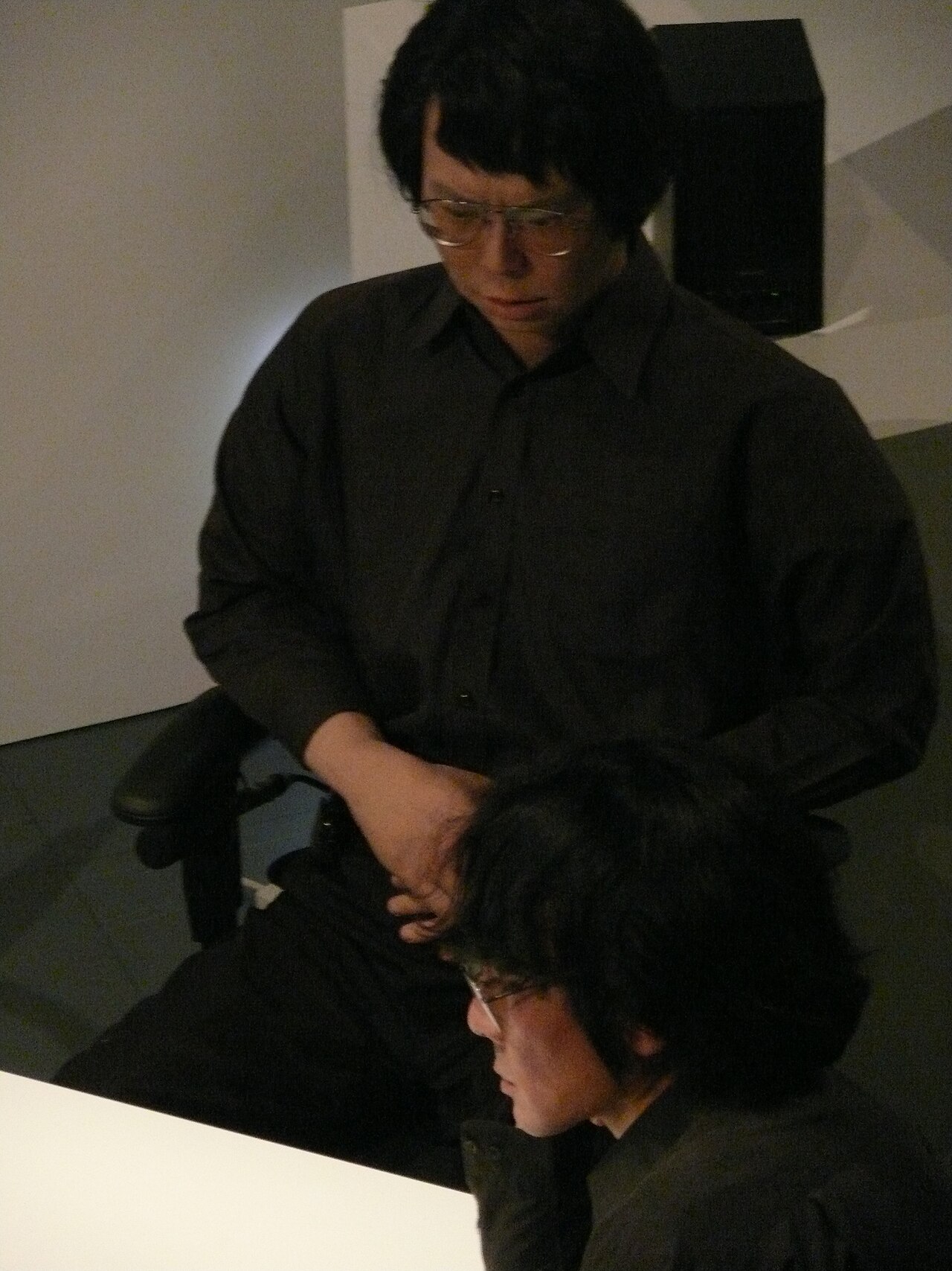Roboticist Hiroshi Ishiguro seated beside Geminoid HI-1, the android built as his physical double, at Ars Electronica Festival 2009.